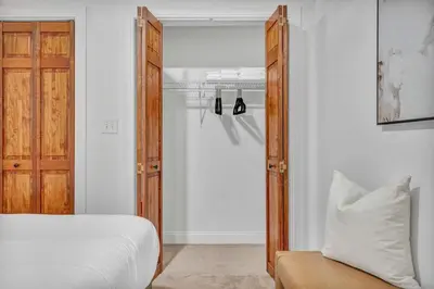 a bedroom with a bed and a mirror and a closet at Lofts on E 4th, WALK TO CAVS, Sleeps 6 in Cleveland