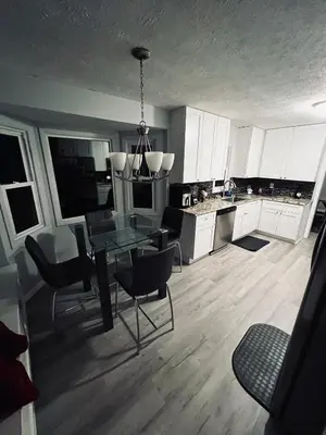 a kitchen with a glass table and chairs in it at Luxury Urban Oasis!15 Min From Downtown Cleveland in Cleveland