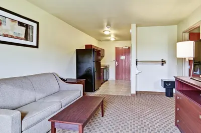 a living room with a couch and a table at Cobblestone Inn & Suites - Ambridge in Ambridge