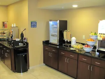 a kitchen with a counter with bowls of fruit on it at Cobblestone Inn & Suites - Ambridge in Ambridge