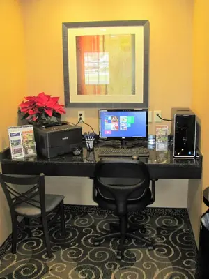 a desk with a laptop computer and a printer at Cobblestone Inn & Suites - Ambridge in Ambridge