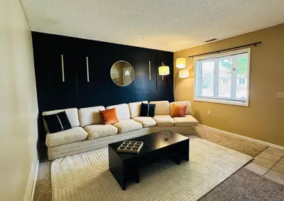 a living room with a couch and a table at Tranquility in Trenton -Sleeps 9 in Trenton