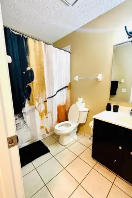 a bathroom with a toilet and a shower and a sink at Tranquility in Trenton -Sleeps 9 in Trenton