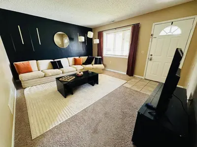 a living room with a couch and a tv at Tranquility in Trenton -Sleeps 9 in Trenton