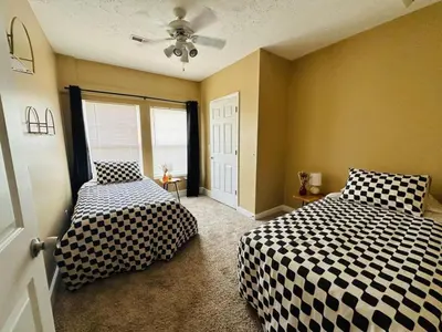 a bedroom with two beds and a ceiling fan at Tranquility in Trenton -Sleeps 9 in Trenton