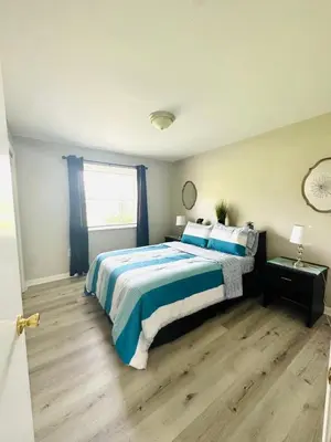 a bedroom with a large bed and a window at 2 Homes for large group Hot Tub in Mason