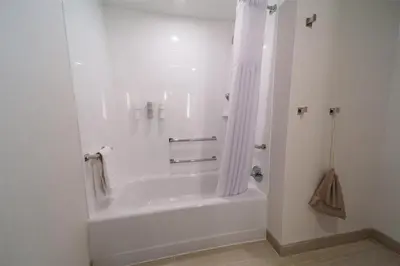a white bathroom with a tub and a shower at Hilton Garden Inn Dayton Downtown in Dayton