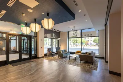 a lobby with couches and chairs and windows at Hilton Garden Inn Dayton Downtown in Dayton