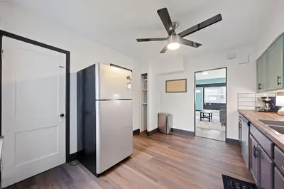 a kitchen with a refrigerator and a ceiling fan at Welcome to the Treasure house! in Westlake