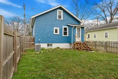 a blue house with a wooden fence in a yard at Welcome to the Treasure house! in Westlake