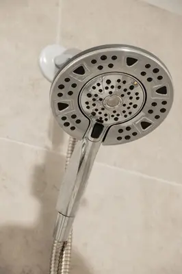 a shower with a shower head in a bathroom at Sleep like a King - OTR- Free Light Rail ! in Cincinnati