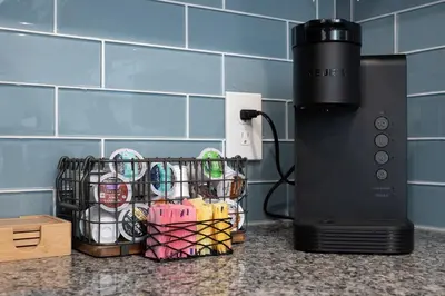 a coffee maker on a counter next to a basket of dishes at Sleep like a King - OTR- Free Light Rail ! in Cincinnati