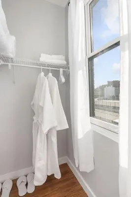 a room with white towels and a window at Sleep like a King - OTR- Free Light Rail ! in Cincinnati