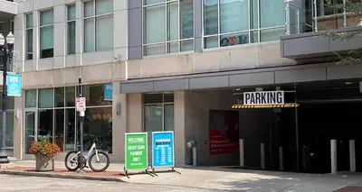 a building with a parking sign in front of it at Sleep like a King - OTR- Free Light Rail ! in Cincinnati