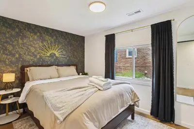 a bedroom with a large bed and a window at Charming 3-Bedroom - Hot Tub & Game Room in Vermilion