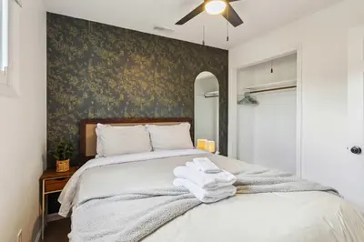 a bedroom with a bed with towels on it at Charming 3-Bedroom - Hot Tub & Game Room in Vermilion
