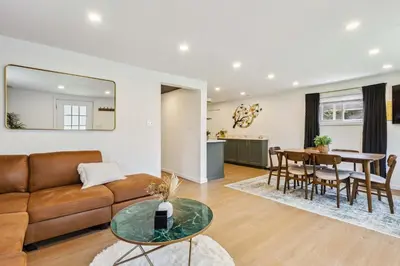 a living room with a couch and a table at Charming 3-Bedroom - Hot Tub & Game Room in Vermilion