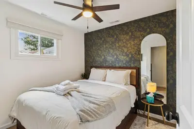a bedroom with a bed with a ceiling fan at Charming 3-Bedroom - Hot Tub & Game Room in Vermilion