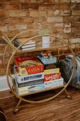 a pile of books sitting on a coffee table at Stunning 4BR Townhome Rooftop City Views in Cincinnati