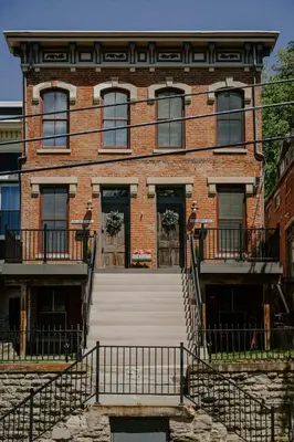 a large brick building with stairs in front of it at Stunning 4BR Townhome Rooftop City Views in Cincinnati