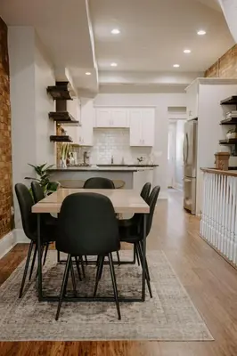 a kitchen and dining room with a table and chairs at Stunning 4BR Townhome Rooftop City Views in Cincinnati