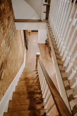 a staircase in an old building with wooden floors at Stunning 4BR Townhome Rooftop City Views in Cincinnati