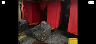 two chairs in a room with red curtains at Tarawa drive in Cincinnati