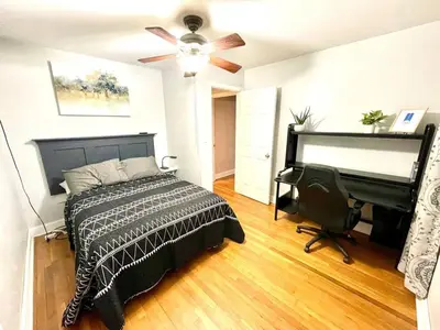 a bedroom with a bed and a desk and a ceiling fan at Large Private Ranch - Master Bedroom Suite with King Bed and private Bathroom - Fenced Yard - Pets & Kids Welcome - Pool Table in Columbus