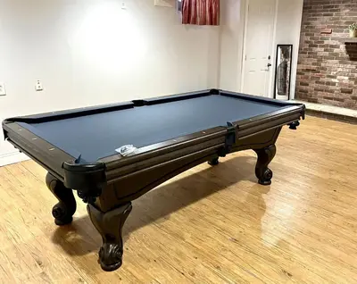 a pool table sitting on top of a wooden floor at Large Private Ranch - Master Bedroom Suite with King Bed and private Bathroom - Fenced Yard - Pets & Kids Welcome - Pool Table in Columbus