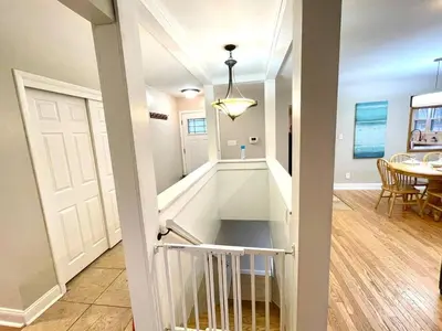 a stairway leading into a living room with a table at Large Private Ranch - Master Bedroom Suite with King Bed and private Bathroom - Fenced Yard - Pets & Kids Welcome - Pool Table in Columbus