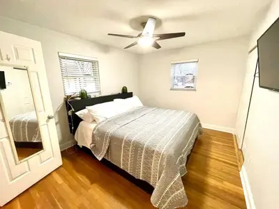 a bedroom with a bed and a ceiling fan at Large Private Ranch - Master Bedroom Suite with King Bed and private Bathroom - Fenced Yard - Pets & Kids Welcome - Pool Table in Columbus
