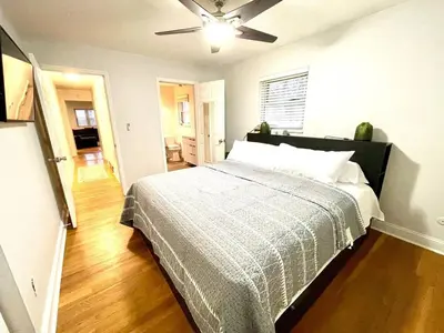 a bedroom with a bed and a ceiling fan at Large Private Ranch - Master Bedroom Suite with King Bed and private Bathroom - Fenced Yard - Pets & Kids Welcome - Pool Table in Columbus