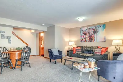 a living room with a couch and a table and chairs at 17 Mi to Columbus Pickerington Home with Fire Pit! in Pickerington