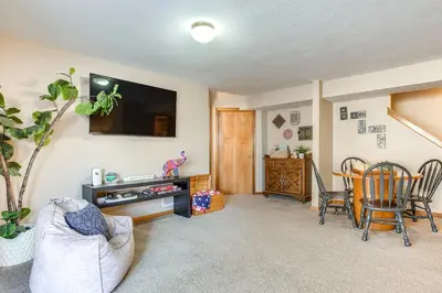 a living room with a tv and a table and chairs at 17 Mi to Columbus Pickerington Home with Fire Pit! in Pickerington