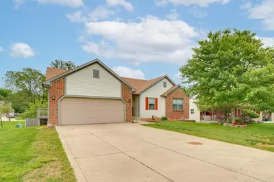 a house with a garage and a tree at 17 Mi to Columbus Pickerington Home with Fire Pit! in Pickerington