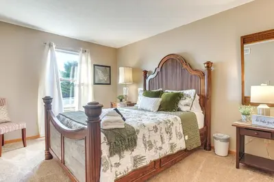 a bedroom with a wooden bed with green pillows at 17 Mi to Columbus Pickerington Home with Fire Pit! in Pickerington