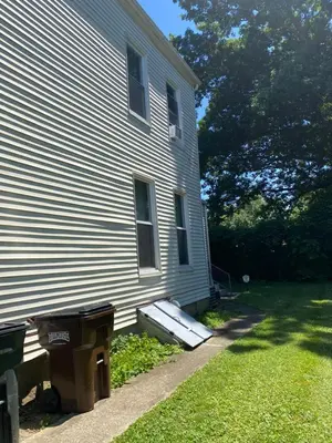 a house with a ramp next to a building at Cozy Studio Private room in Cincinnati