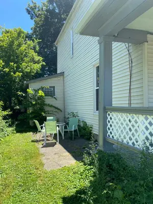 a yard with chairs and a table and a house at Cozy Studio Private room in Cincinnati