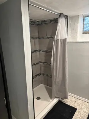 a shower in a bathroom with a shower curtain at Cozy Studio Private room in Cincinnati
