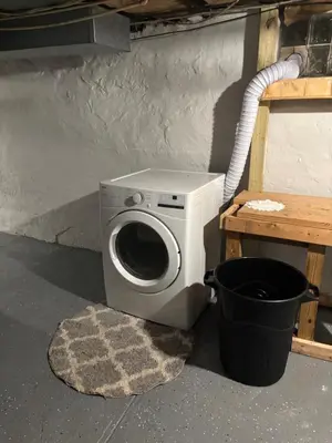 a washing machine is sitting next to a table at Cozy Studio private room deluxe in Cincinnati