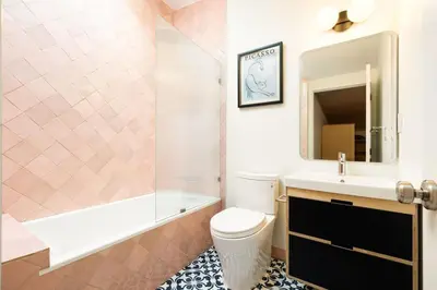 a bathroom with a toilet and a sink and a tub at Luxury Loft near Washington Park - Rooftop Deck in Cincinnati
