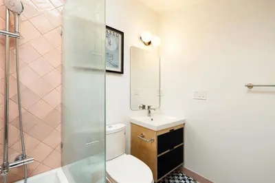 a bathroom with a toilet and a sink and a shower at Luxury Loft near Washington Park - Rooftop Deck in Cincinnati