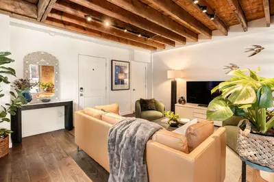 a living room with a couch and a tv at Luxury Loft near Washington Park - Rooftop Deck in Cincinnati