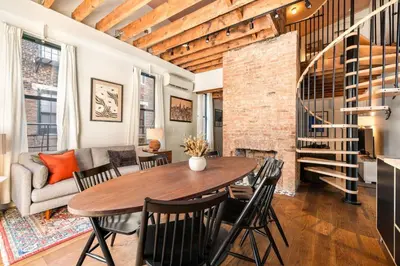 a dining room and living room with a table and chairs at Luxury Loft near Washington Park - Rooftop Deck in Cincinnati