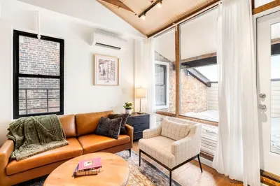 a living room with a couch and a table at Washington Park - Rooftop Patio - Free Streetcar in Cincinnati