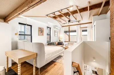a living room with a couch and a table at Washington Park - Rooftop Patio - Free Streetcar in Cincinnati