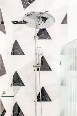 a glass table in front of a wall with black triangles at Washington Park - Rooftop Patio - Free Streetcar in Cincinnati
