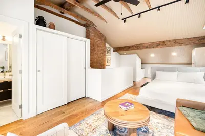 a bedroom with a bed and a table at Washington Park - Rooftop Patio - Free Streetcar in Cincinnati