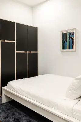 a white bedroom with a large bed and a picture at Washington Park - Rooftop Patio - Free Streetcar in Cincinnati