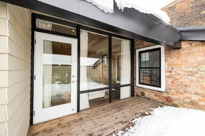 a sliding glass door on a brick building at Washington Park - Rooftop Patio - Free Streetcar in Cincinnati